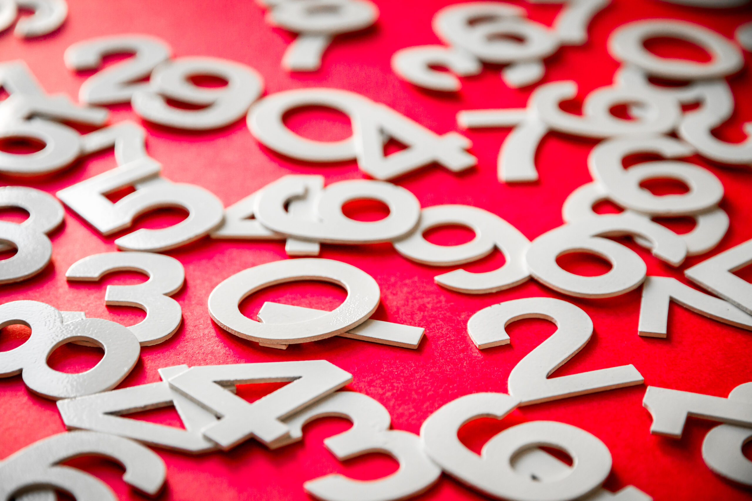 Mathematics background made with solid numbers on a board. Isolated on red
